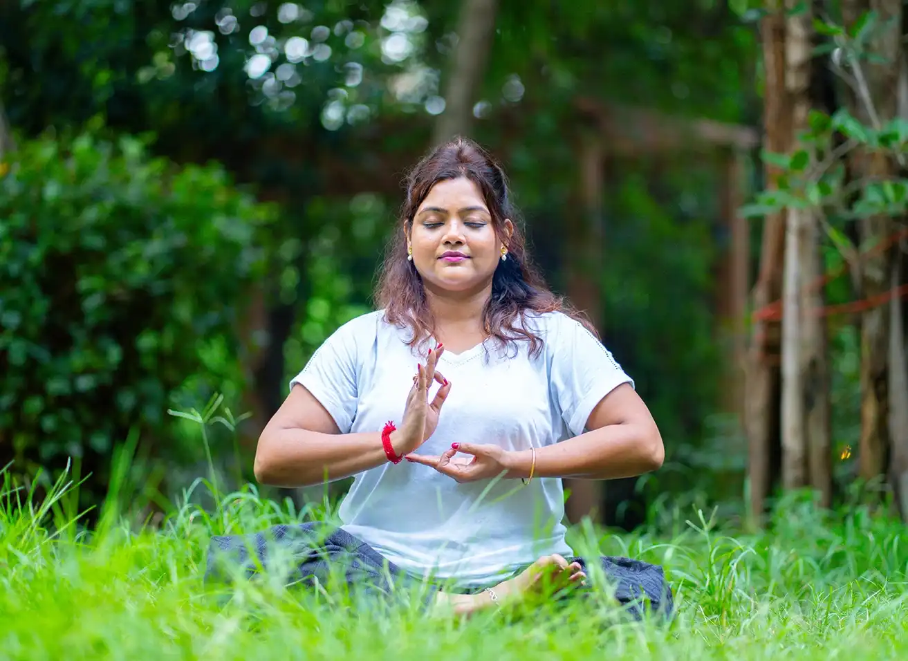 A serene practitioner performing Trataka Meditation with candle gazing at Nabatara Foundation.